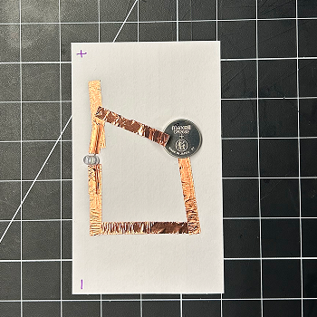 Instead of one piece of tape, I put two down and then taped the light down so it would be two paths, one positive and one negative.